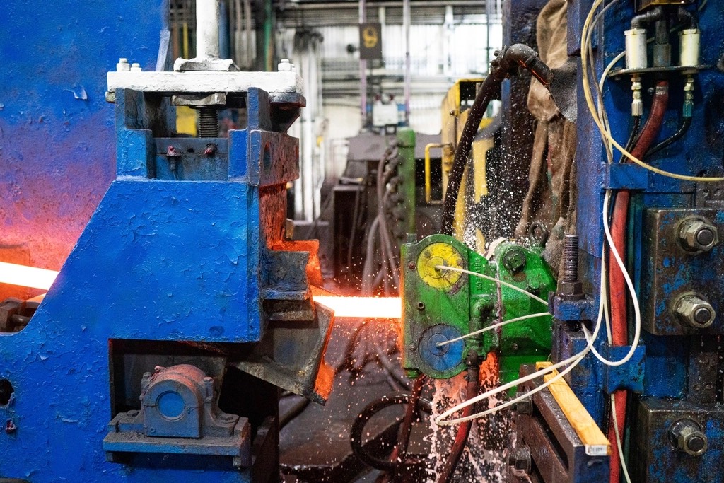 Hot steel being worked in a steel mill